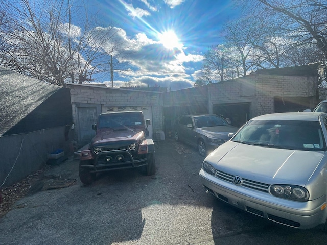 view of parking / parking lot featuring a garage