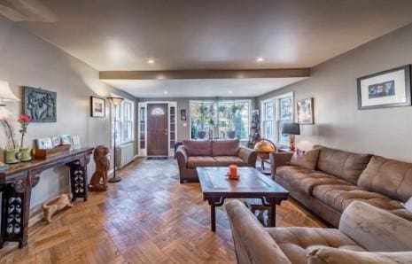 living room with a wealth of natural light and parquet floors