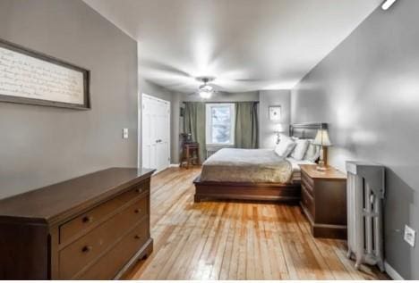 bedroom with light wood-type flooring and ceiling fan