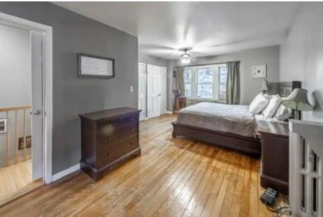 bedroom with ceiling fan and wood-type flooring