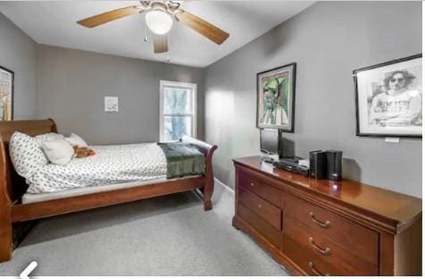 bedroom featuring ceiling fan and light carpet