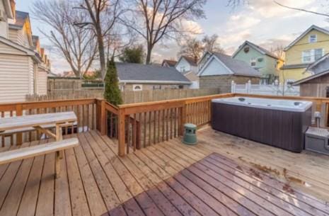 deck at dusk with a hot tub