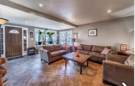 living room with beamed ceiling and parquet flooring