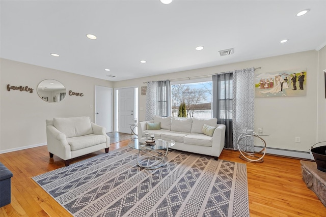 living room with baseboard heating and hardwood / wood-style floors