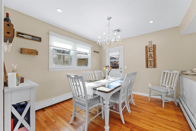 dining room with an inviting chandelier, light hardwood / wood-style flooring, and a baseboard radiator