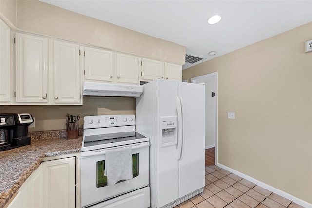 kitchen with white cabinets, light tile patterned floors, and white appliances