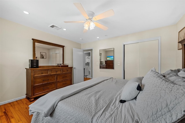 bedroom featuring light wood-type flooring, ceiling fan, and a closet