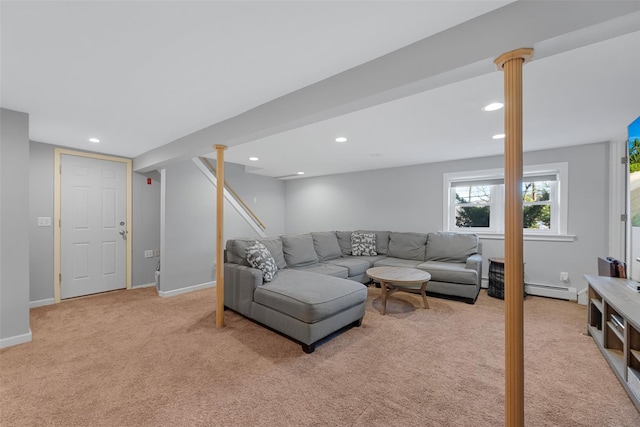 carpeted living room featuring decorative columns and a baseboard radiator