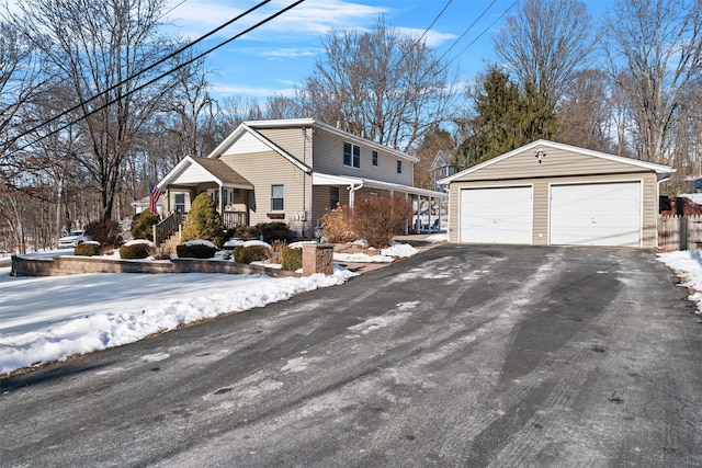 view of front facade featuring a garage and an outbuilding