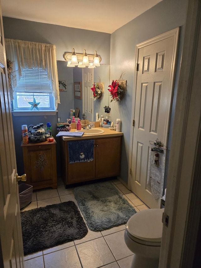 bathroom featuring toilet, vanity, and tile patterned floors