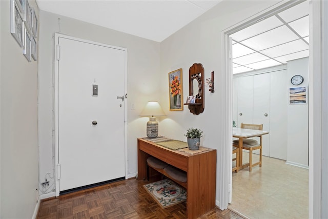 foyer entrance with dark parquet floors