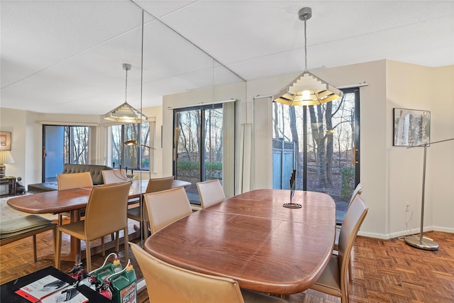 dining space with parquet floors and plenty of natural light