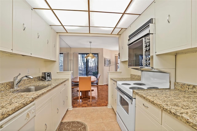 kitchen featuring hanging light fixtures, sink, white cabinetry, white appliances, and light parquet flooring