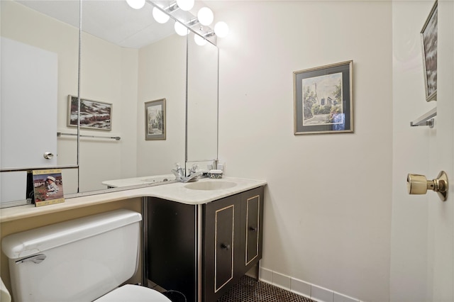 bathroom featuring vanity, toilet, and tile patterned flooring