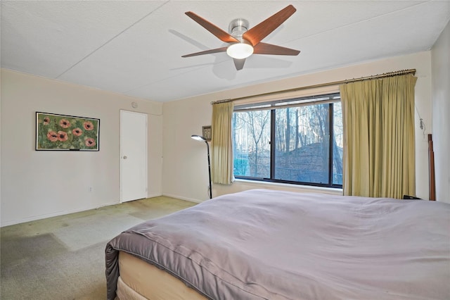 carpeted bedroom with ceiling fan and a textured ceiling