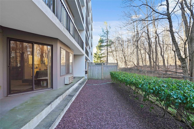 view of side of property featuring a wall mounted AC