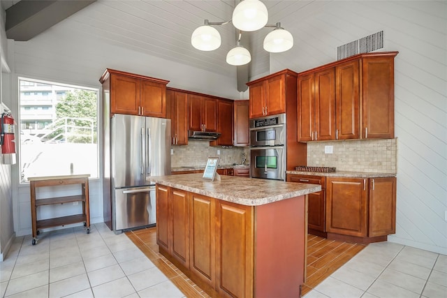 kitchen featuring a kitchen island, hanging light fixtures, light tile patterned floors, and appliances with stainless steel finishes