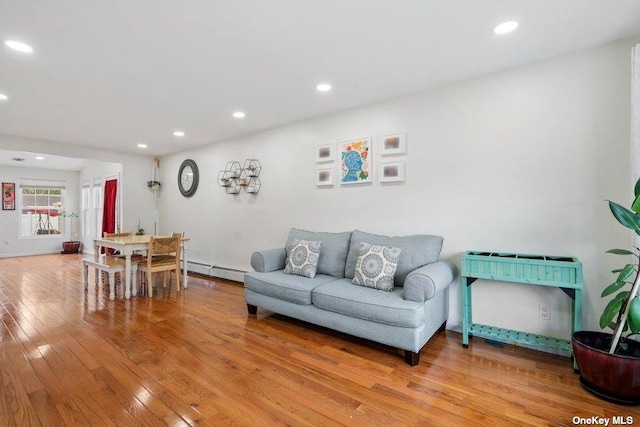 living room with baseboard heating and hardwood / wood-style flooring