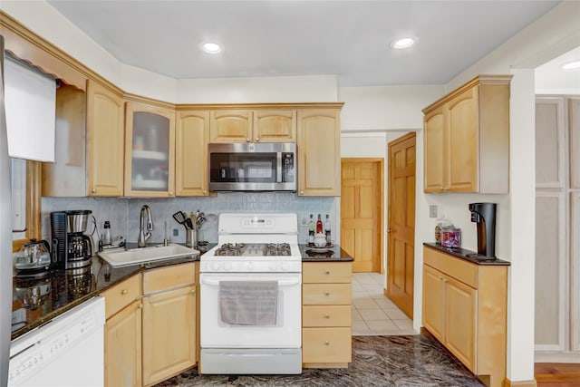 kitchen featuring light brown cabinets, white appliances, sink, and tasteful backsplash