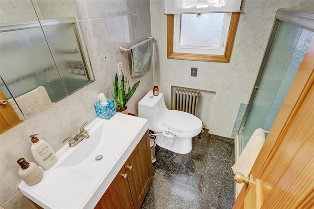 bathroom with vanity, toilet, tile walls, walk in shower, and radiator heating unit