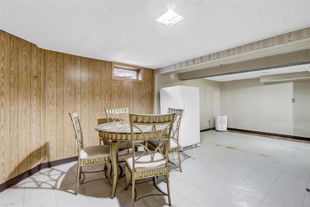 dining space with wood walls