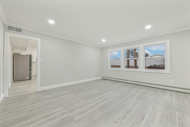 spare room featuring light wood-type flooring, ornamental molding, and a baseboard radiator