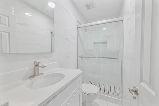 bathroom featuring vanity, an enclosed shower, tile walls, and toilet