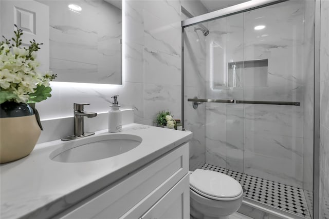 bathroom featuring vanity, tile walls, toilet, and walk in shower