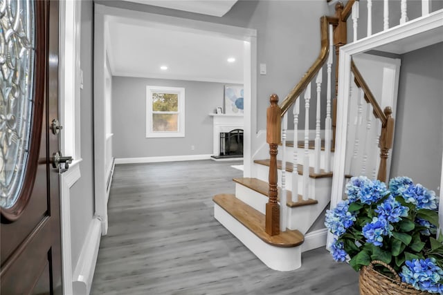 foyer with baseboard heating and wood-type flooring