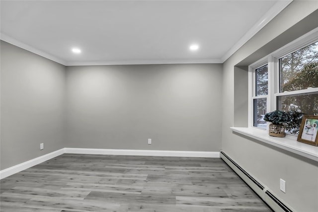 empty room with a baseboard radiator, ornamental molding, and light wood-type flooring