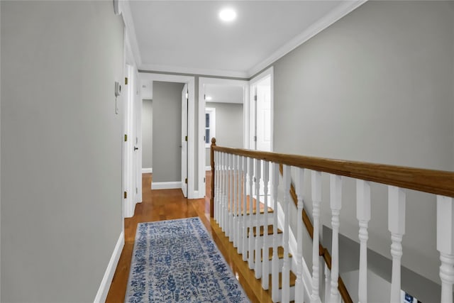 hall with ornamental molding and hardwood / wood-style floors