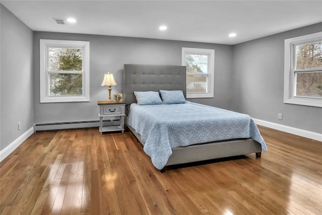 bedroom featuring a baseboard radiator and light wood-type flooring