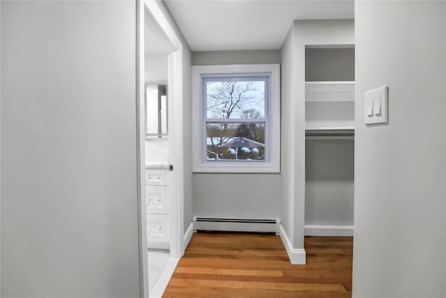 interior space with light wood-type flooring and baseboard heating