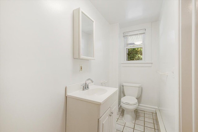 bathroom featuring tile patterned floors, vanity, and toilet