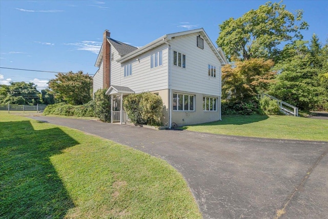 view of property exterior featuring a lawn