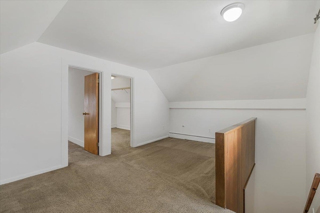 bonus room with carpet floors and vaulted ceiling