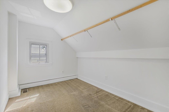 additional living space featuring baseboard heating, carpet flooring, and vaulted ceiling