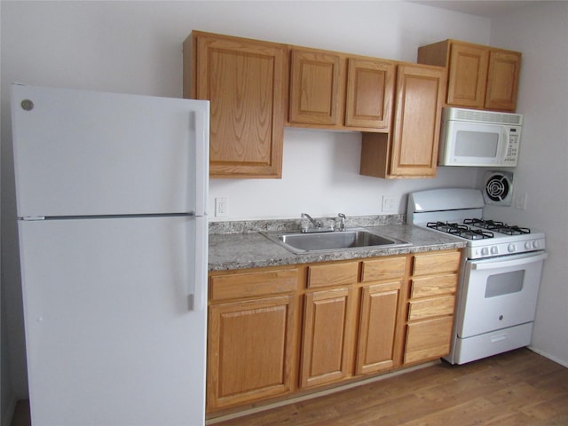 kitchen with sink, white appliances, and light hardwood / wood-style flooring