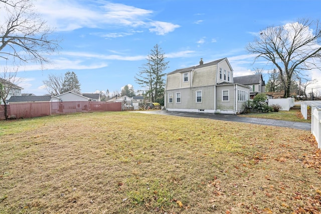 rear view of property featuring a lawn