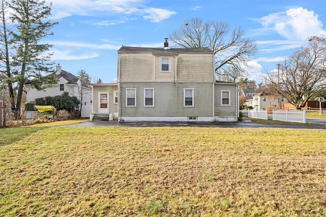 back of house featuring a yard