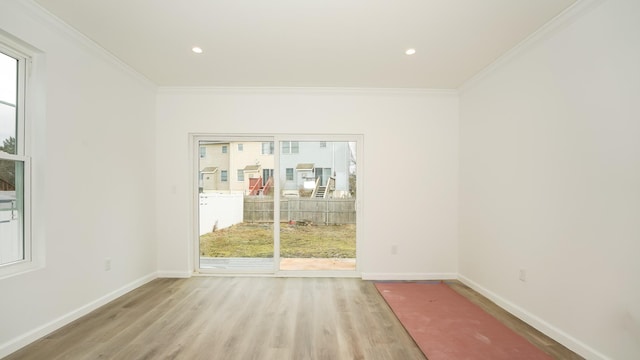 unfurnished room featuring light hardwood / wood-style floors and ornamental molding