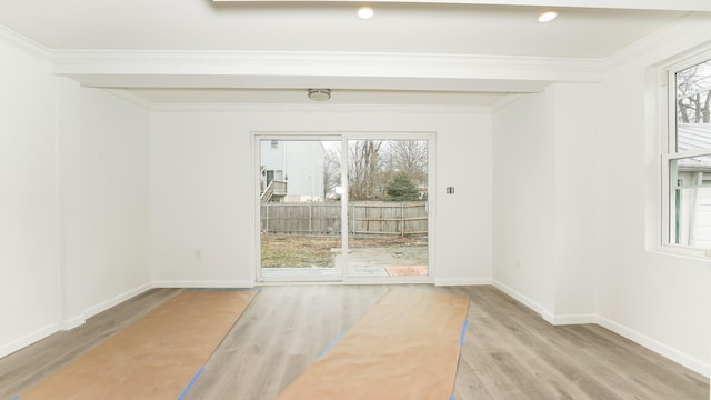 entryway with hardwood / wood-style flooring and crown molding