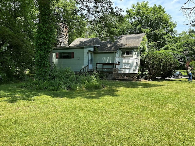 back of house featuring a yard