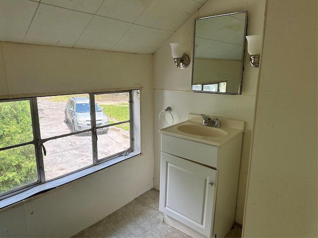 bathroom with vanity and lofted ceiling