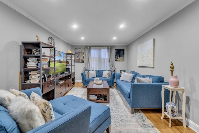 living room with light wood-type flooring and crown molding