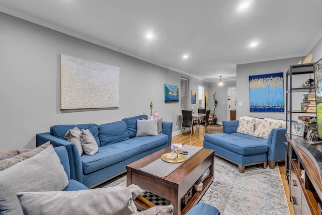 living room featuring ornamental molding and light hardwood / wood-style flooring