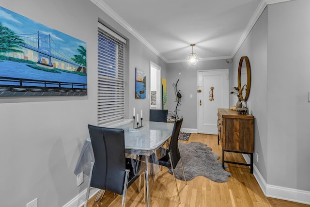 dining room featuring crown molding and wood-type flooring