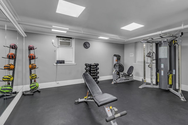 workout area featuring crown molding and an AC wall unit