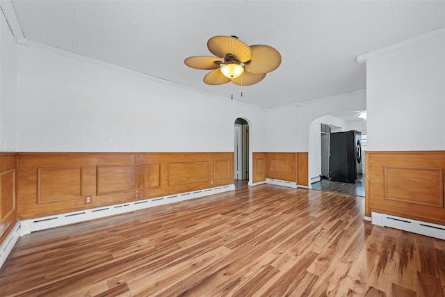 unfurnished living room with hardwood / wood-style flooring, crown molding, ceiling fan, and baseboard heating