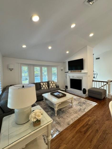 living room with dark hardwood / wood-style flooring and vaulted ceiling